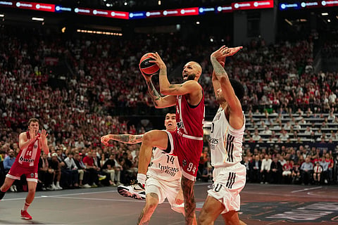 Olympiacos' Evan Fournier drives to the basket against Real Madrid's Andres Feliz during the Euroleague final basketball match between Olympiacos and Real Madrid in Athens, Greece.