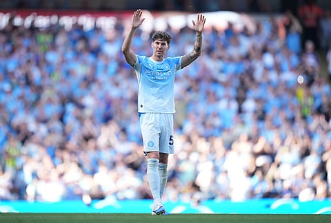 Manchester City's John Stones walks off the pitch after playing the ;ast game for the club during a Premier League soccer match between Manchester City and Aston Villa in Manchester, England.
