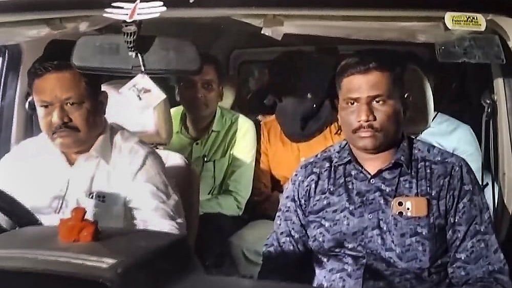 CBI officials take accused Shubham Khairnar into custody in connection with the NEET-UG 2026 paper leak case and leave for Delhi for further investigation, in Nashik, Tuesday, May 12, 2026.  - | Photo: PTI