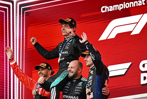 First-place finisher Mercedes driver Kimi Antonelli, top, of Italy, is held aloft by second-place finisher Ferrari driver Lewis Hamilton, left, of Britain, and Mercedes senior composite technician Dean Hale, second from right, as third-place finisher Red Bull Racing driver Max Verstappen, right, of the Netherlands, joins them following the F1 Canadian Grand Prix auto race in Montreal.