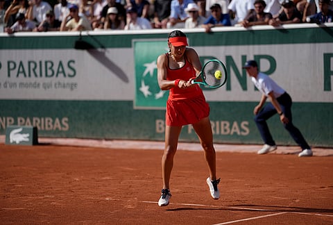 Emma Raducanu of Britain returns to Solana Sierra of Argentina during their first round women's singles tennis match against Solana Sierra of Argentina at the French Open tennis tournament in Paris.