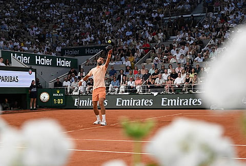 Novak Djokovic of Serbia serves to Giovanni Mpetshi Perricard of France during their first round men's singles tennis match at the French Open tennis tournament in Paris.