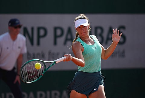 Solana Sierra of Argentina returns to Emma Raducanu of Britain during their first round women's singles tennis match against Solana Sierra of Argentina at the French Open tennis tournament in Paris.