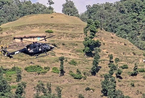 A helicopter carrying reinforcement personnel flies over an area during an ongoing anti-terror operation, in Rajouri district, Jammu and Kashmir. The encounter between security forces and terrorists entered its fourth consecutive day. 