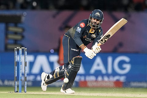 Gujarat Titans' Rahul Tewatia plays a shot during the Indian Premier League cricket match between Gujarat Titans and Royal Challengers Bengaluru in Dharamshala, India.