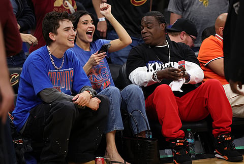 Timothée Chalamet, left, Kylie Jenner, center, and Tracy Morgan watch the second half of Game 4 in the Eastern Conference finals NBA basketball playoffs series between the New York Knicks and the Cleveland Cavaliers in Cleveland.