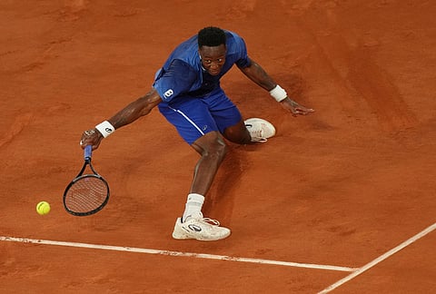Gael Monfils of France returns to Hugo Gaston of France during their first round men's singles tennis match at the French Open tennis tournament in Paris.