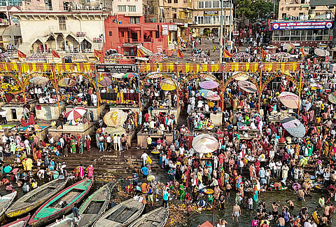People gather to take a holy dip in the Ganga, in Varanasi, Uttar Pradesh.