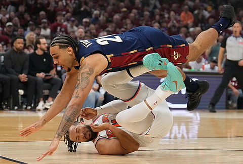 Cleveland Cavaliers guard Jaylon Tyson (20) collides with New York Knicks guard Jalen Brunson (11) during the first half of Game 4 in the Eastern Conference finals NBA basketball playoffs series in Cleveland.
