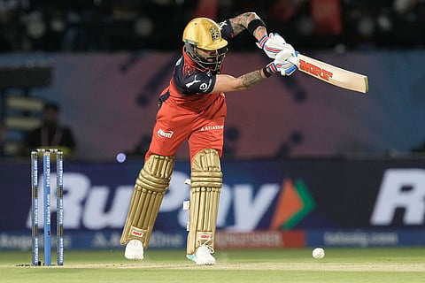 Royal Challengers Bengaluru's Virat Kohli plays a shot during the Indian Premier League cricket match between Gujarat Titans and Royal Challengers Bengaluru in Dharamshala, India.
