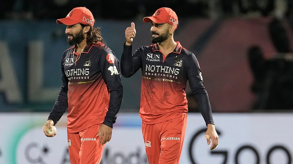 Rajat Patidar, left, celebrates with teammate Virat Kohli after taking the catch to dismiss Rahul Tewatia during the Indian Premier League match between Gujarat Titans and Royal Challengers Bengaluru in Dharamsala. - AP