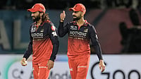 IPL Dispatch: Rajat Patidar Embodies RCB's Killer Instinct; RR Battling Odds In Eliminator AP : Rajat Patidar, left, celebrates with teammate Virat Kohli after taking the catch to dismiss Rahul Tewatia during the Indian Premier League match between Gujarat Titans and Royal Challengers Bengaluru in Dharamsala.