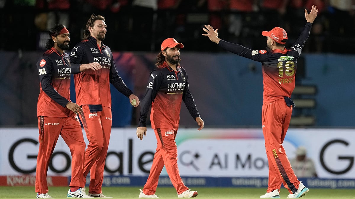 Royal Challengers Bengaluru's Virat Kohli, right, and teammates celebrate after their win in the Indian Premier League cricket match against Gujarat Titans in Dharamshala. - AP Photo