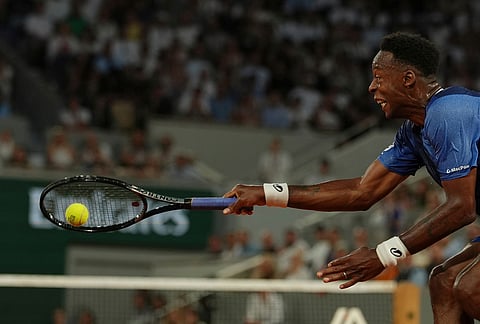 Gael Monfils of France returns to Hugo Gaston of France during their first round men's singles tennis match at the French Open tennis tournament in Paris.