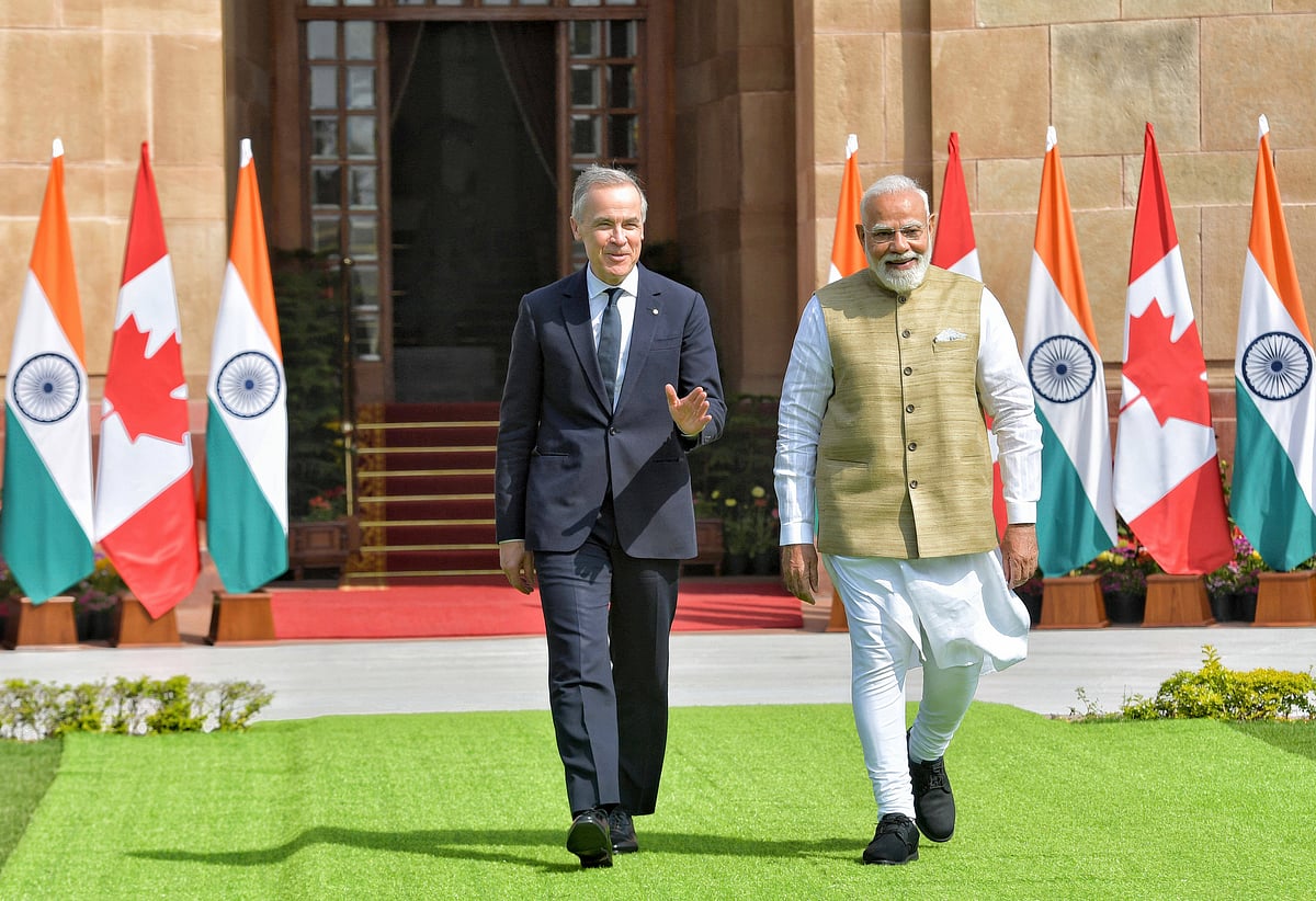 Indian Prime Minister Narendra Modi, right, walks with Canadian Prime Minister Mark Carney, left, following a bilateral meeting at Hyderabad House - IMAGO