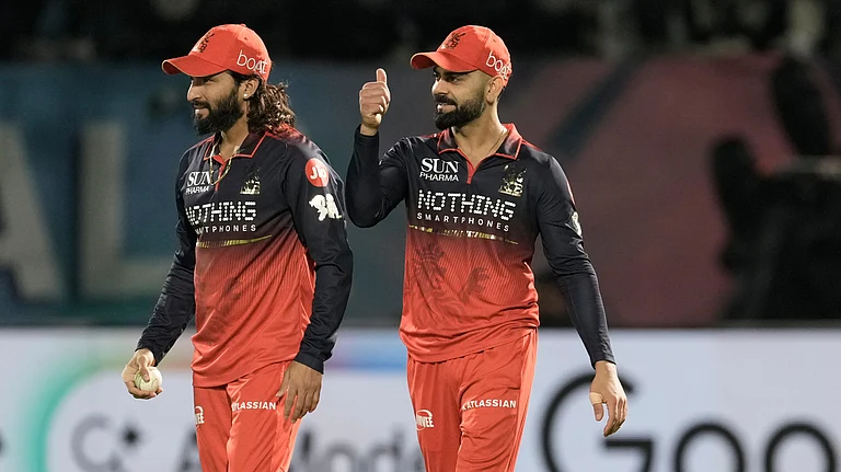 Royal Challengers Bengaluru's captain Rajat Patidar, left, celebrates with teammate Virat Kohli after taking the catch to dismiss Gujarat Titans' Rahul Tewatia during the Indian Premier League cricket match between Gujarat Titans and Royal Challengers Bengaluru in Dharamshala. - AP Photo