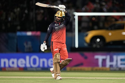 Royal Challengers Bengaluru's captain Rajat Patidar celebrates his fifty runs during the Indian Premier League cricket match between Gujarat Titans and Royal Challengers Bengaluru in Dharamshala, India.