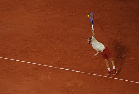 Hugo Gaston of France serves to Gael Monfils of France during their first round men's singles tennis match at the French Open tennis tournament in Paris.
