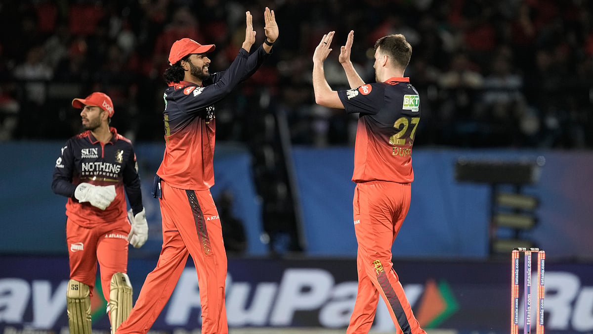 RCB cricketers celebrate after taking a wicket of GT during IPL 2026.  - AP Photo