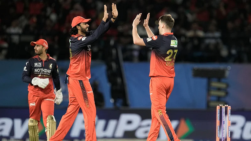 AP Photo : RCB cricketers celebrate after taking a wicket of GT during IPL 2026.