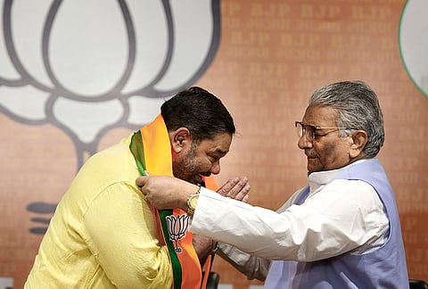 Odisha BJP in-charge Vijaypal Singh Tomar felicitates former BJD MP Debashish Samantaray after the latter joins BJP during a press conference, at the party headquarters, in New Delhi.