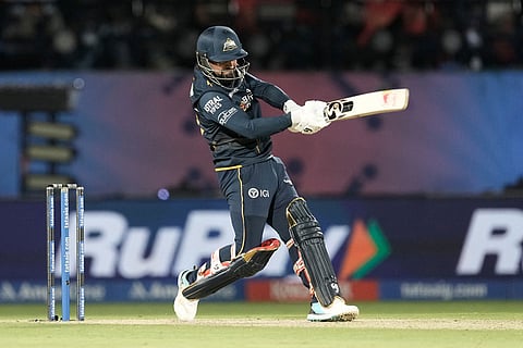 Gujarat Titans' Rashid Khan hits a six during the Indian Premier League cricket match between Gujarat Titans and Royal Challengers Bengaluru in Dharamshala, India.