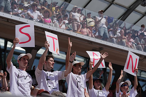 Fans support Stan Wawrinka of Switzerland during his first round men's singles tennis match against Jesper De Jong of the Netherlands at the French Open tennis tournament in Paris.