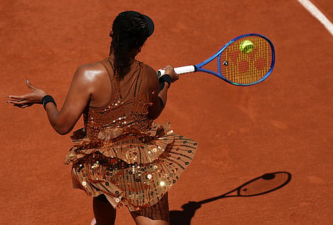 Naomi Osaka of Japan returns to Laura Siegemund of Germany during their first round women's singles tennis match at the French Open tennis tournament in Paris.