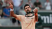 Photo: AP : Novak Djokovic of Serbia celebrates after winning against Valentin Royer of France during their second round men's singles tennis match at the French Open tennis tournament in Paris.