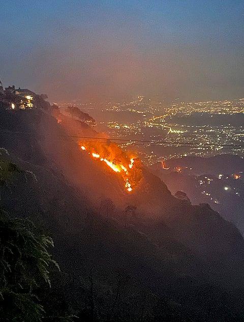 A forest fire rages through the hills, in Kasauli, Himachal Pradesh. Army personnel, the Indian Air Force, cantonment authorities and fire services launched a joint operation to contain the blaze and protect heritage areas. 