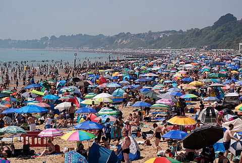 People visit Bournemouth beach, south England.