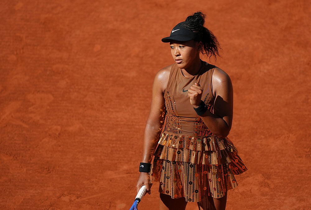 Naomi Osaka of Japan celebrates as she plays against Laura Siegemund of Germany during their first round women's singles tennis match at the French Open tennis tournament in Paris. - | Photo: AP/Aurelien Morissard