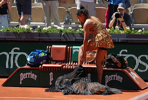Naomi Osaka of Japan prepares for the first round women's singles tennis match against Laura Siegemund of Germany at the French Open tennis tournament in Paris.