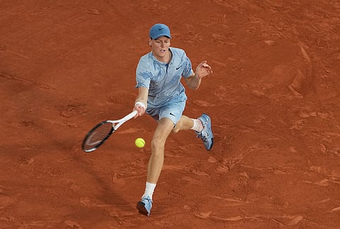 Jannik Sinner of Italy returns to Clement Tabur of France during their first round men's singles tennis match at the French Open tennis tournament in Paris.