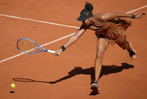 Naomi Osaka of Japan returns to Laura Siegemund of Germany during their first round women's singles tennis match at the French Open tennis tournament in Paris.