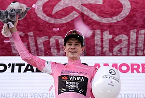 | Photo: Massimo Paolone/LaPresse via AP : Denmark's Jonas Vingegaard wears the pink jersey of the race overall leader as he celebrates winning the 16th stage of the Giro d'Italia cycling race from Bellinzona to Cari', Switzerland.