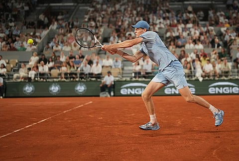 Jannik Sinner of Italy returns to Clement Tabur of France during their first round men's singles tennis match at the French Open tennis tournament in Paris.
