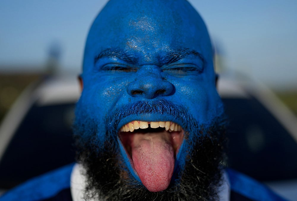 Brenton Balentien, known as Blue Face, a leader of soccer fans of Curacaos national soccer team, cheers in Willemstad.
