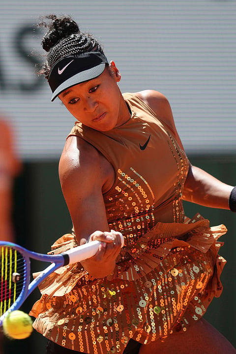 Naomi Osaka of Japan returns to Laura Siegemund of Germany during their first round women's singles tennis match at the French Open tennis tournament in Paris.
