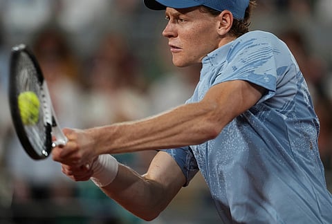 Jannik Sinner of Italy returns to Clement Tabur of France during their first round men's singles tennis match at the French Open tennis tournament in Paris.