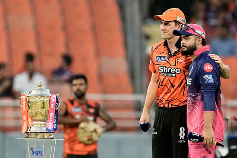 Sunrisers Hyderabad's captain Pat Cummins, and Rajasthan Royals' captain Riyan Parag standing next to the winners' trophy pose for the photograph before the coin toss of the Indian Premier League cricket match between Rajasthan Royals and Sunrisers Hyderabad in New Chandigarh, India.