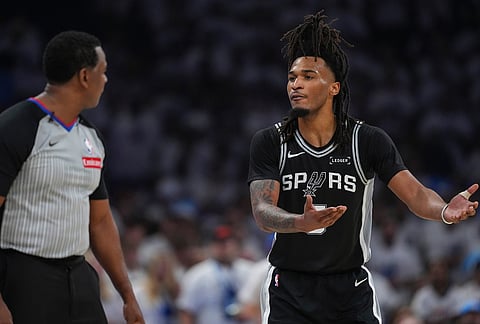 San Antonio Spurs guard Stephon Castle (5) speaks to referee Sean Wright in the first half of Game 5 in the Western Conference finals NBA basketball playoffs series against the Oklahoma City Thunder in Oklahoma City. 