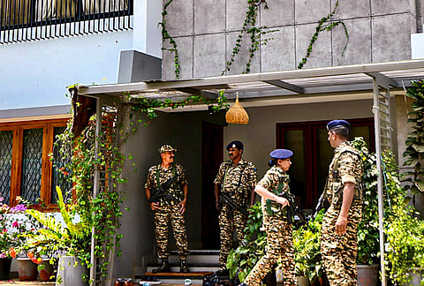 Security personnel stand guard outside the residence of former Kerala PWD minister and Beypore MLA Muhammad Riyas during an Enforcement Directorate raid in connection with the CMRL money laundering case, at Kottuli in Kozhikode. Simultaneous raids were conducted at multiple locations across Kerala. 