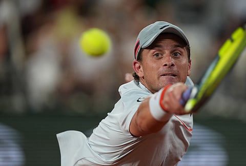 Clement Tabur of France returns to Jannik Sinner of Italy during their first round men's singles tennis match at the French Open tennis tournament in Paris.