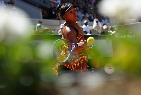 Naomi Osaka of Japan returns to Laura Siegemund of Germany during their first round women's singles tennis match at the French Open tennis tournament in Paris.