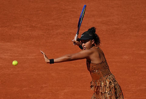 Naomi Osaka of Japan returns to Laura Siegemund of Germany during their first round women's singles tennis match at the French Open tennis tournament in Paris.