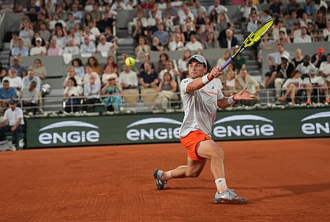 Clement Tabur of France returns to Jannik Sinner of Italy during their first round men's singles tennis match at the French Open tennis tournament in Paris.