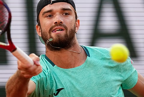 Tomas Machac of the Czech Republic returns to Alexander Zverev of Germany during their second round men's singles tennis match at the French Open tennis tournament in Paris.