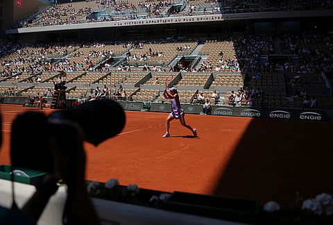 Iga Swiatek of Poland returns to Sara Bejlek of the Czech Republic during their second round women's singles tennis match at the French Open tennis tournament in Paris.