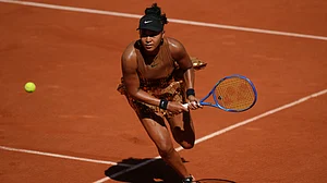 (AP Photo/Aurelien Morissard) : Naomi Osaka of Japan returns to Laura Siegemund of Germany during their first round women's singles tennis match at the French Open tennis tournament in Paris, Tuesday, May 26, 2026.